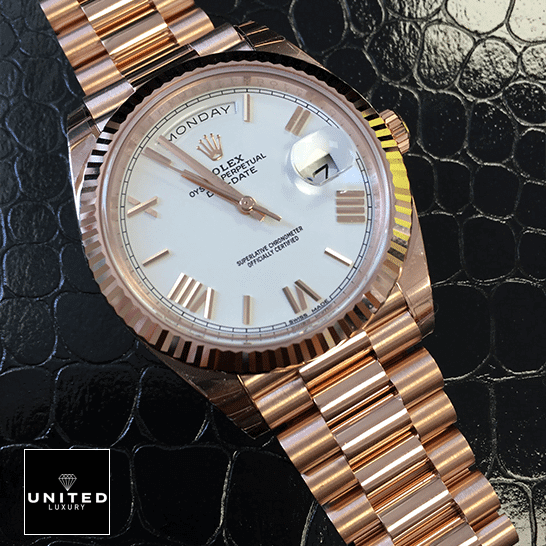 Rolex Day-Date 228235 Rose Gold Replica on the black leather table